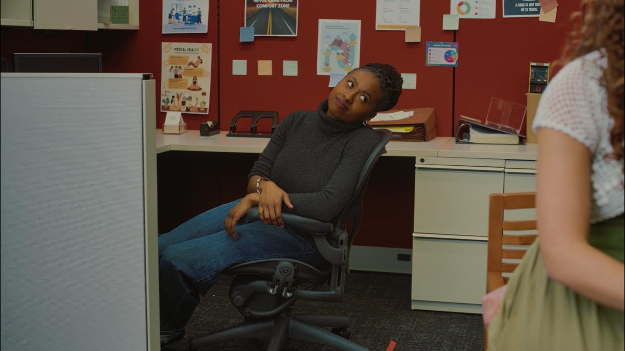 The temp agency interior, warm light against a red accent wall
