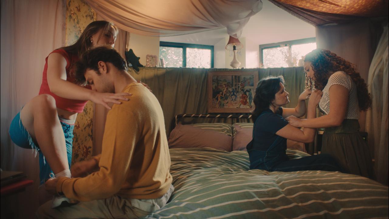 The four tangled together on a bed, a picture of codependency