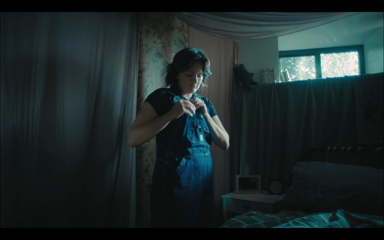 Willa alone in a blue-lit bedroom